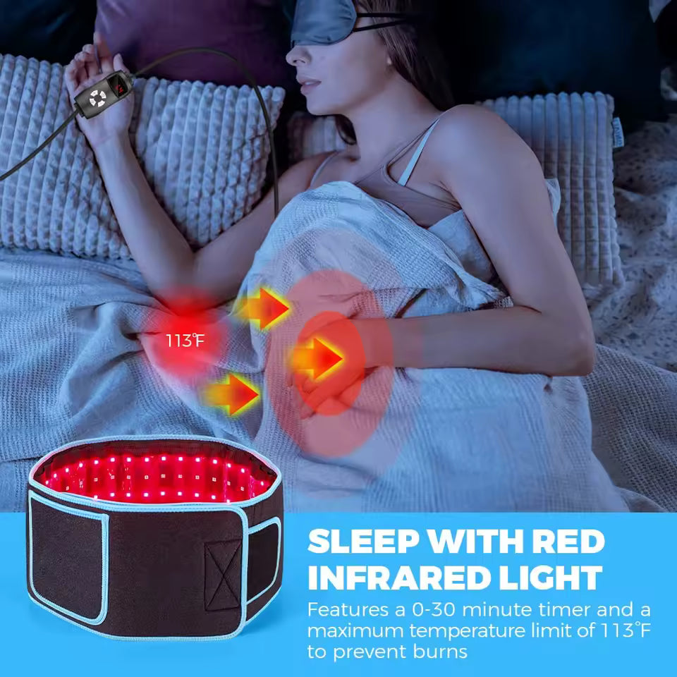Woman relaxing in bed wearing the Soma red light therapy belt around her waist with a warm red infrared glow
